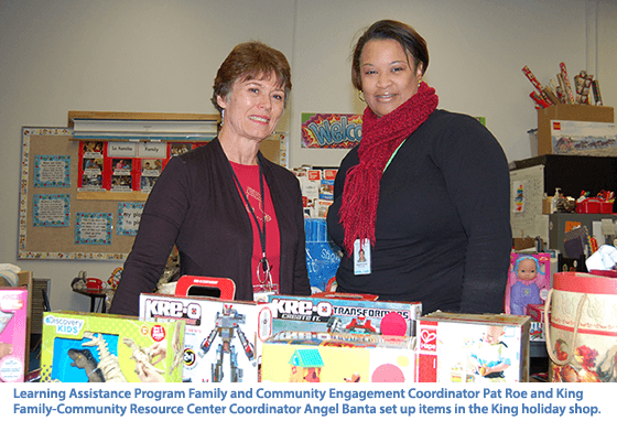 Photo: Learning Assistance Program Family and Community Engagement Coordinator Pat Roe and King  Family-Community Resource Center Coordinator Angel Banta set up items in the King holiday shop.