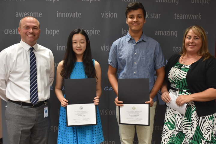 National Merit Semifinalists receive recognition at a school board meeting