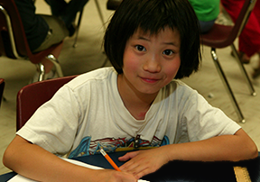 Student in a classroom writing