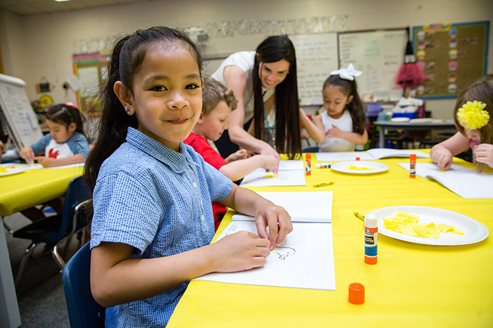 Students practice coloring during a preschool program at Marshall Elementary