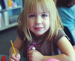 Full-day kindergarten is offered at 10 locations. Student in full-day kindergarten classroom.