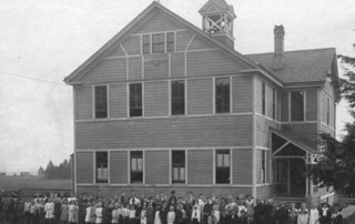 The first Harney School was built and named for Lt. General William S. Harney. Students are standing in front of school.