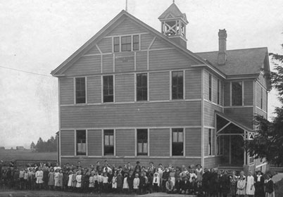 The first Harney School was built and named for Lt. General William S. Harney. Students are standing in front of school.