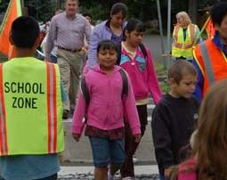Washington Elementary School starts the walking school bus program. Students walk to their designated bu stops and wait for a group of students, volunteers and parents to walk them to school safely.