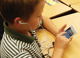 Student uses iTouch device for learning.
