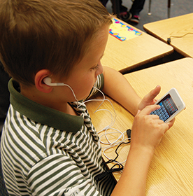 Student uses iTouch device for learning.