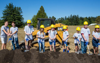 Photo: students with shovels break ground
