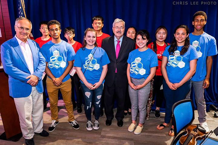 Symphony Koss (front row, second from left) with fellow National Youth Orchestra musicians and U.S. Ambassador to China Terry Branstad (front row, third from left) at the U.S. Embassy in Beijing in July 2018 (photo by Chris Lee, used with photographer permission)