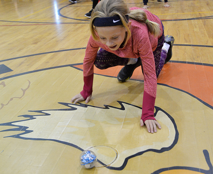 Girl chases after a Sphero robot