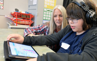 Student uses iPad in coding pilot