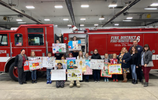Students display their prize-winning posters on fire safety