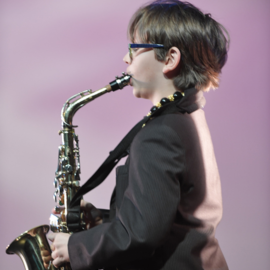 Middle school student playing the saxaphone