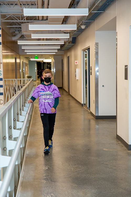 Student walks down hallway