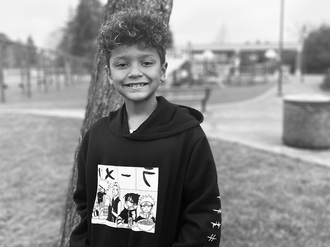 Photo of student Jaden outside in front of playground
