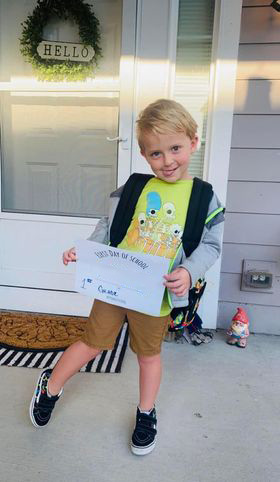 Student poses for a first day of school photo