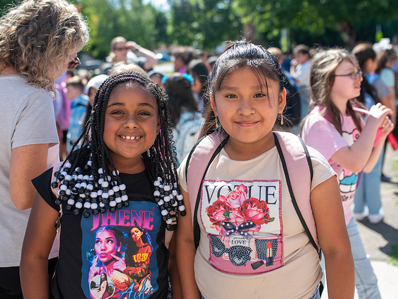 First day of school photo 2024. Two elementary students getting ready to go into the school.