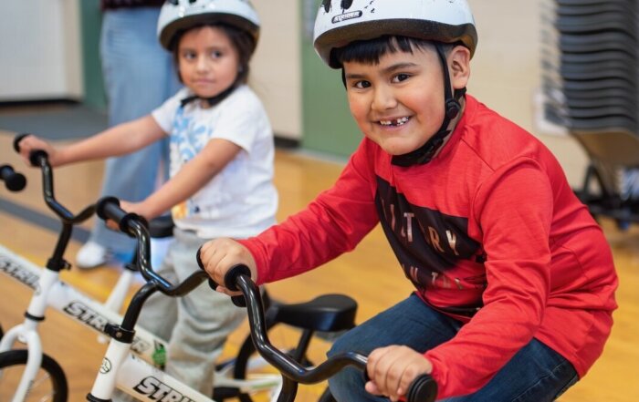 Students at Fruit Valley Elementary School get ready to ride a bike.