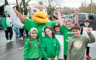 Hough parade Hawk mascot and students